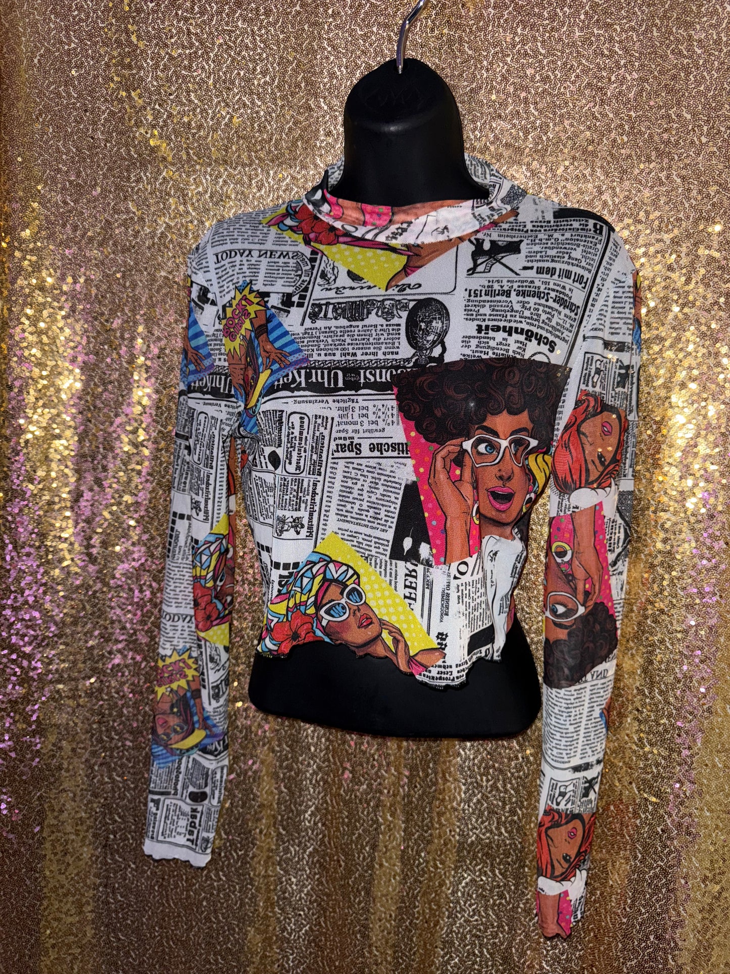 Newspaper print with girl character face mesh crop top